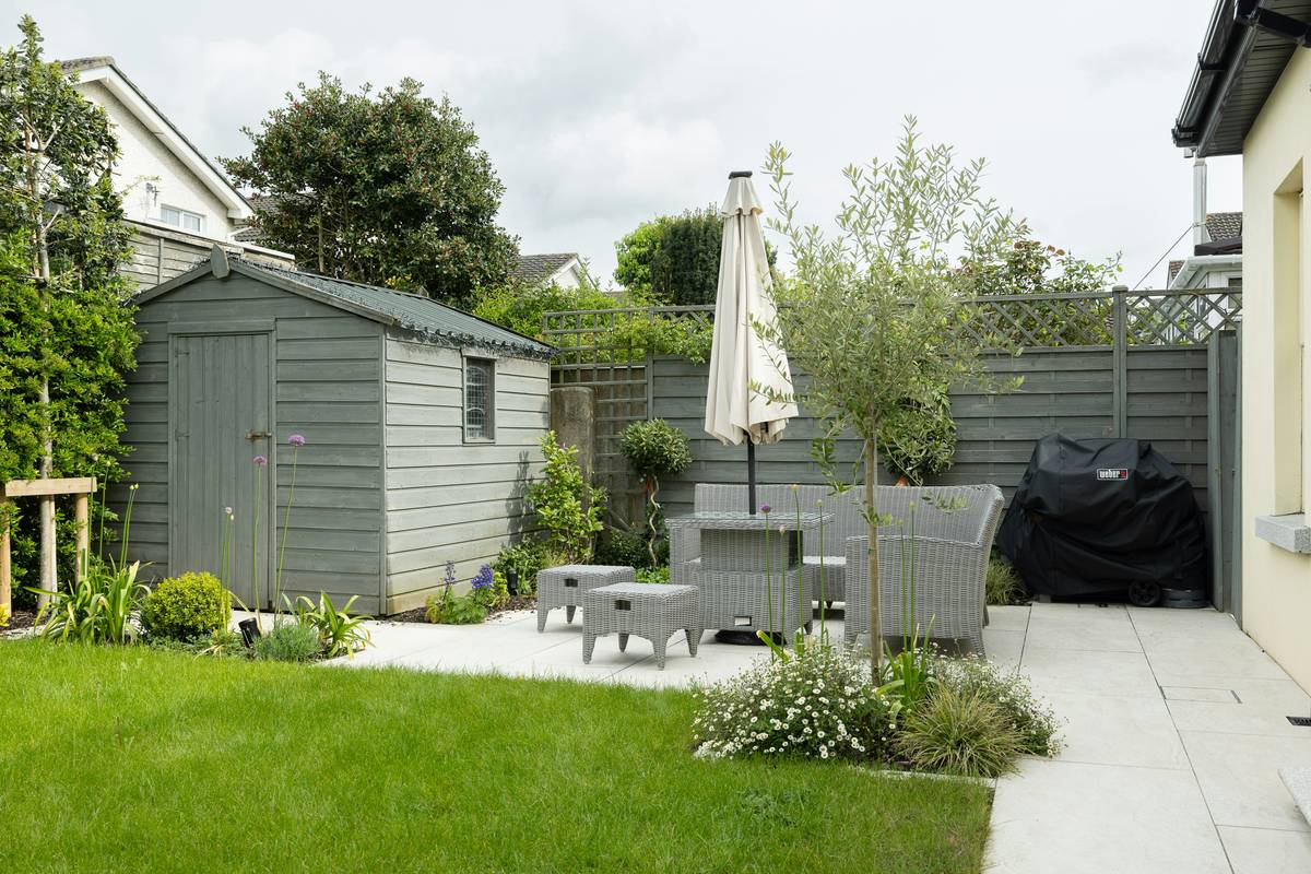 what is garden furniture - durable teak dining set under a heavy-duty garden parasol