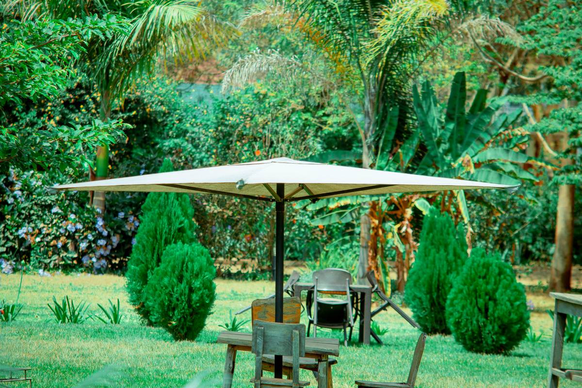 sun protection garden parasol b q mounted over outdoor dining set with cantilever design