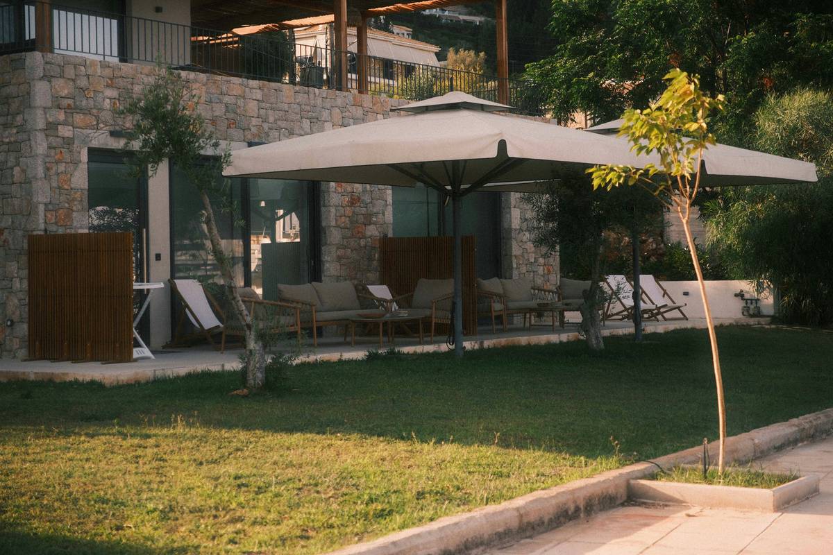 outdoor shade garden parasol large to covering a wooden patio dining set with wicker chairs under summer sunlight